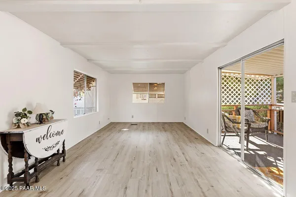 a living room with a couch wooden floor and a table