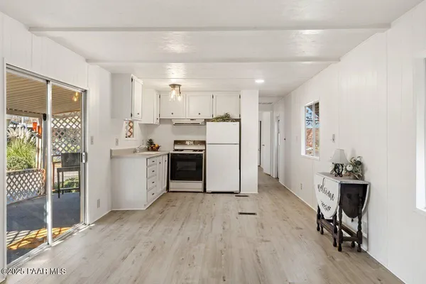 a kitchen with cabinets and wooden floor