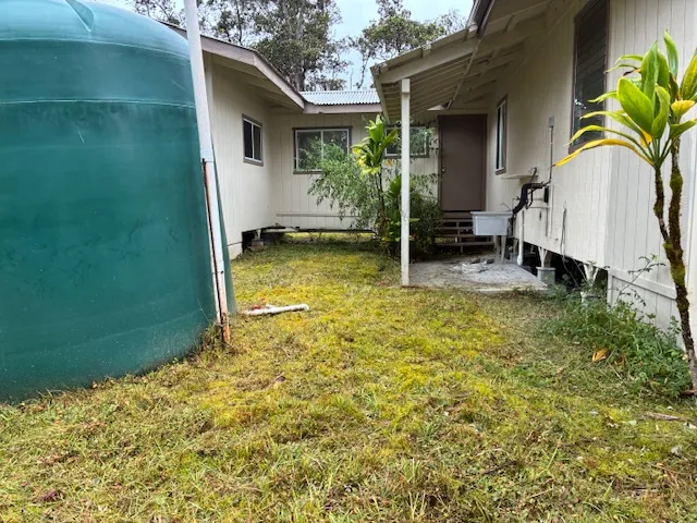 a view of house with backyard and swimming pool