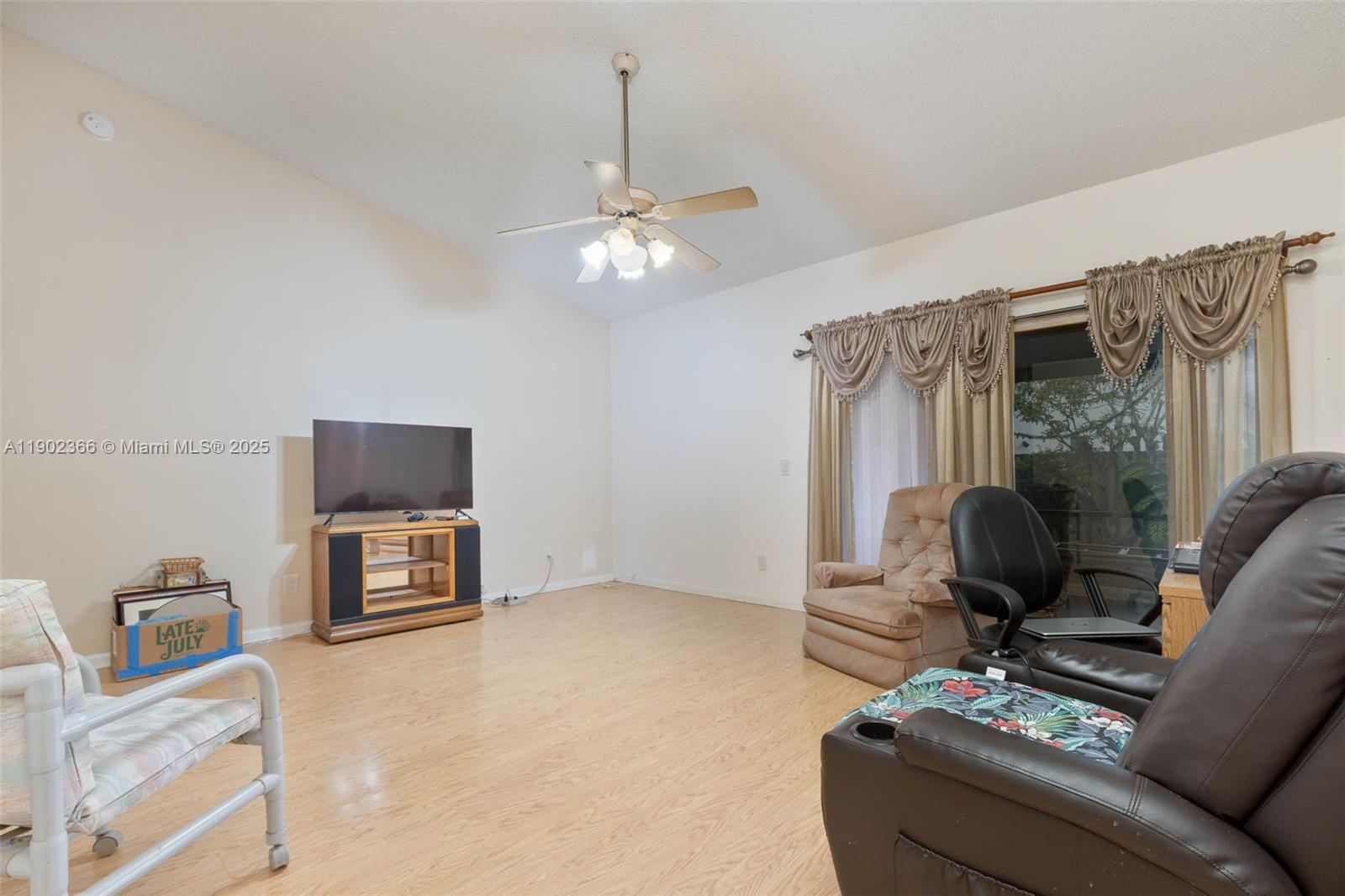 5641 Thistledown Terrace Davie, FL 33331 - Photo 11 of 36 a living room with furniture a flat screen tv and a window
