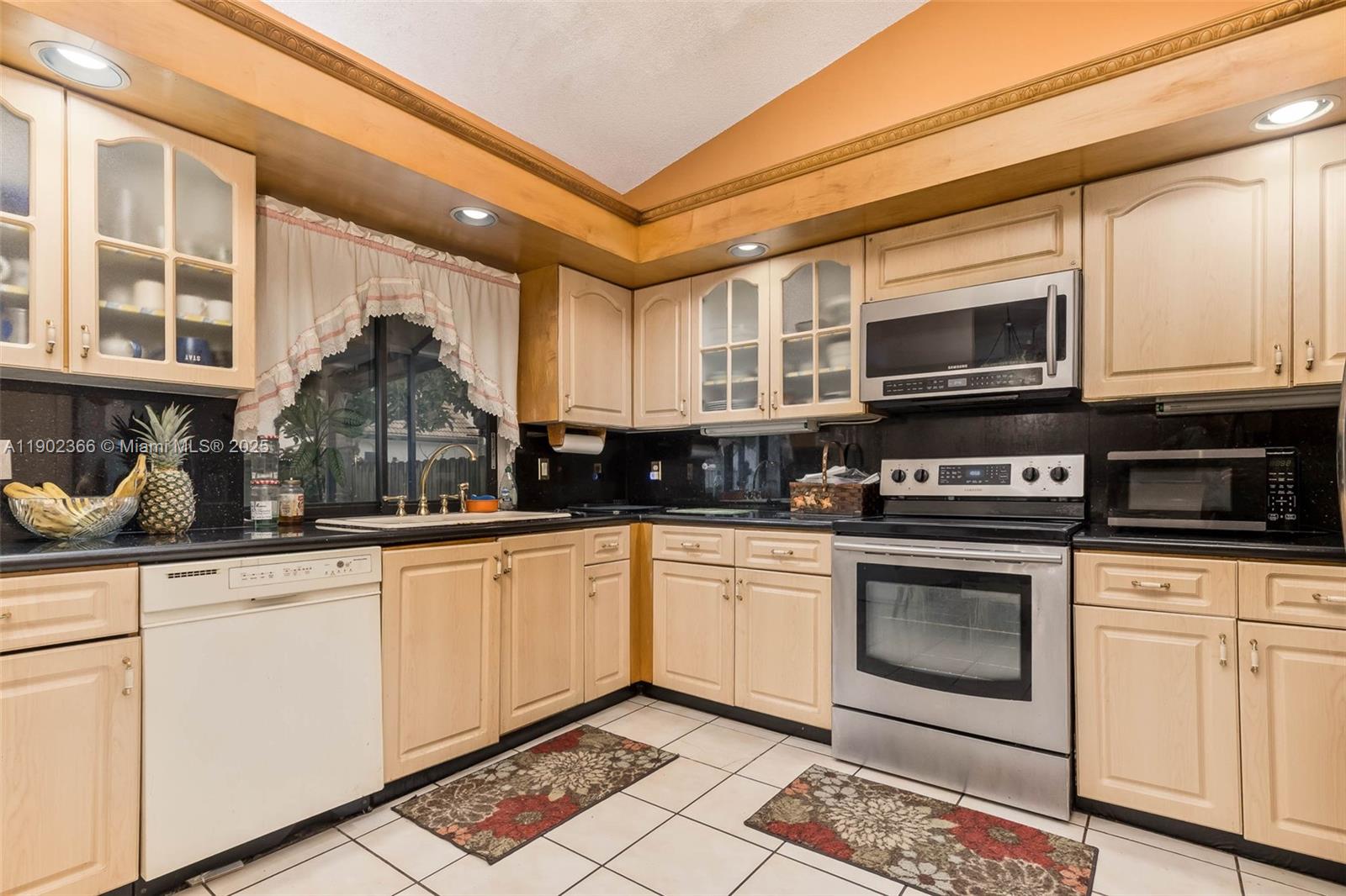5641 Thistledown Terrace Davie, FL 33331 - Photo 13 of 36 a kitchen with stainless steel appliances granite countertop a stove and a microwave