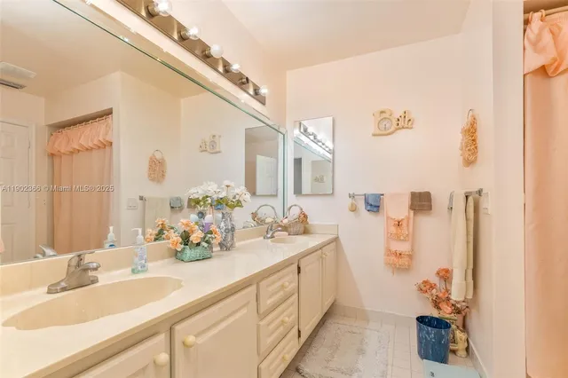 a bathroom with a double vanity sink and a mirror