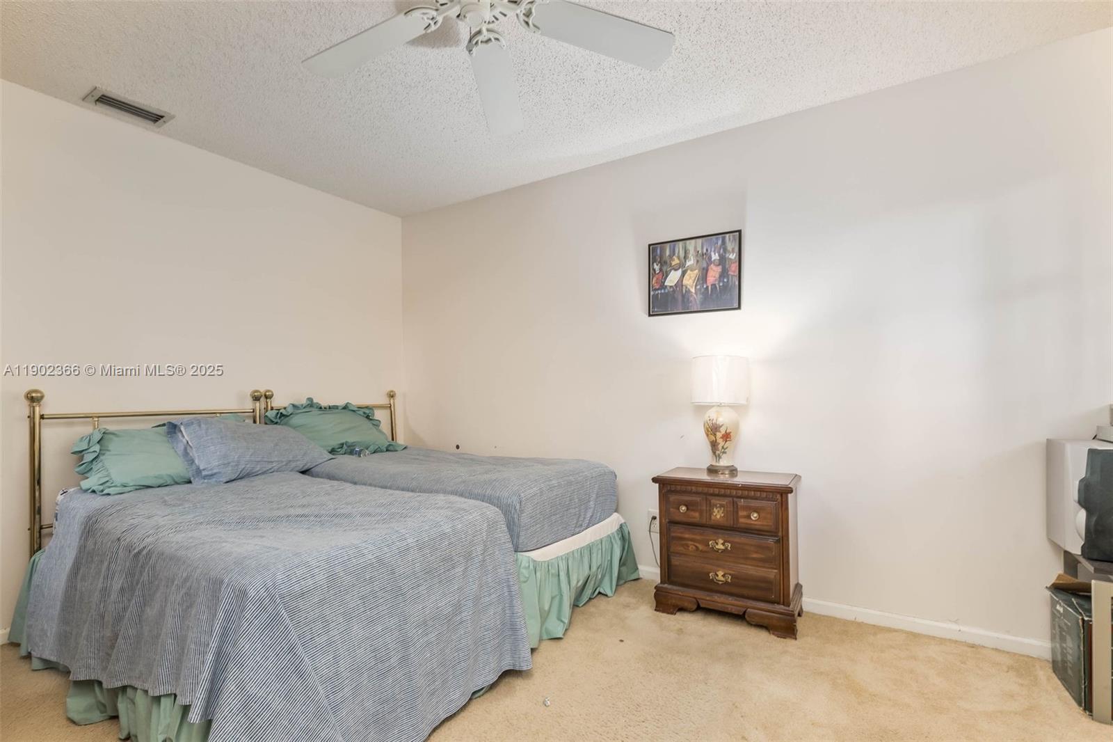 5641 Thistledown Terrace Davie, FL 33331 - Photo 20 of 36 a bedroom with a bed and a lamp on the dresser