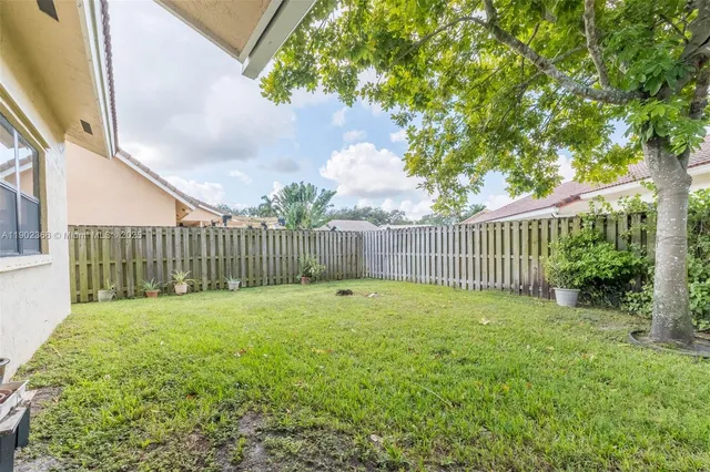 a view of a backyard with fence