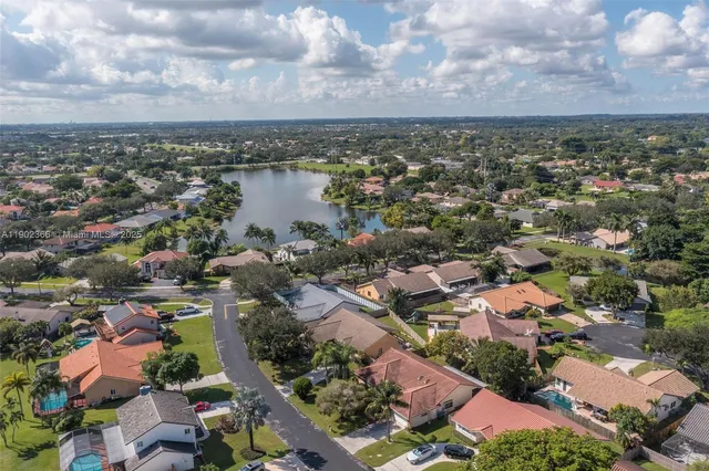 an aerial view of residential building and lake