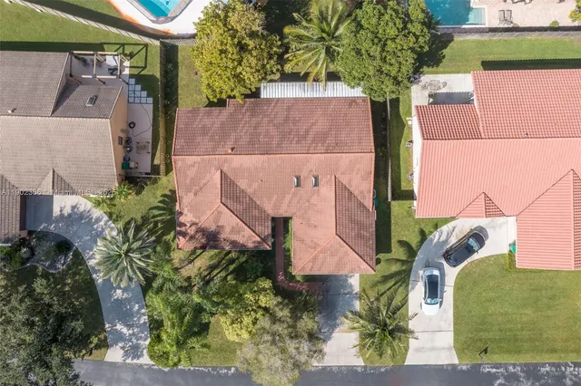 an aerial view of a house with a yard