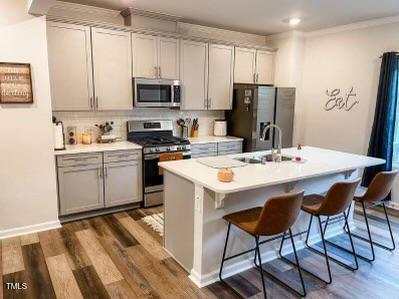 1346 Rosepine Drive Cary, NC 27519 - Photo 10 of 28 a kitchen with a sink stainless steel appliances and white cabinets