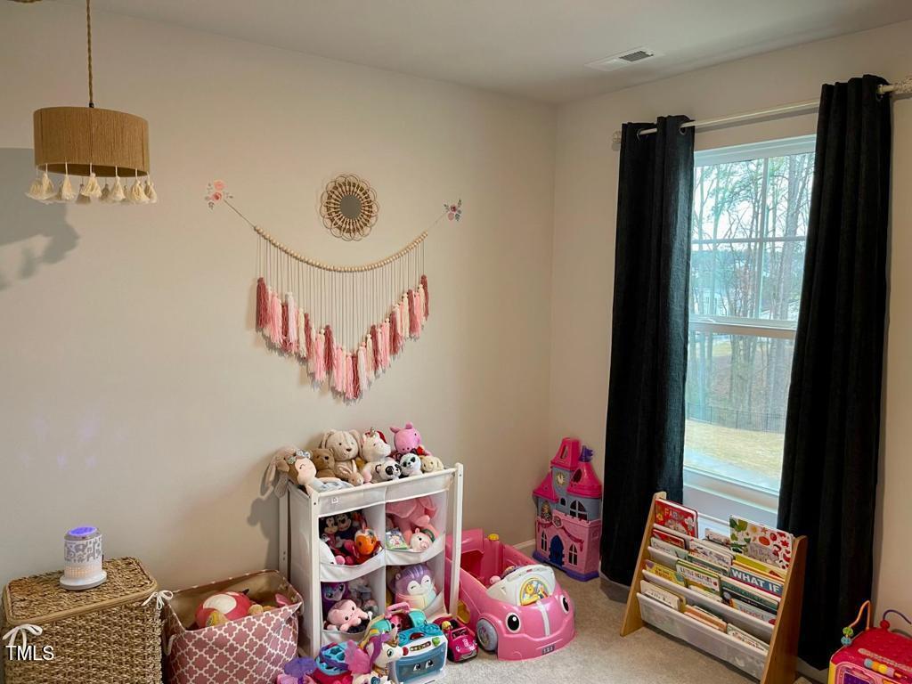 1346 Rosepine Drive Cary, NC 27519 - Photo 15 of 28 a bedroom with toys and a book shelf