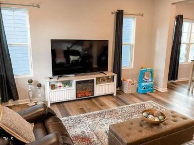 1346 Rosepine Drive Cary, NC 27519 - Photo 7 of 28 a living room with furniture and a flat screen tv