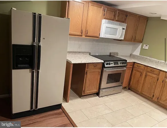 a kitchen with a refrigerator stove and cabinets
