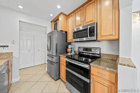 a kitchen with stainless steel appliances granite countertop a refrigerator stove and sink