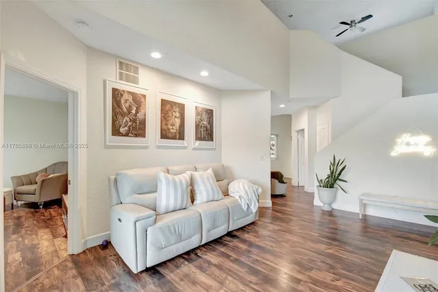 a room with stainless steel appliances kitchen island granite countertop furniture and a refrigerator