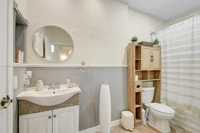 a bathroom with a tub sink and mirror
