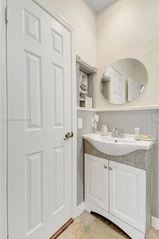a en suite bathroom with a sink a mirror and a shower