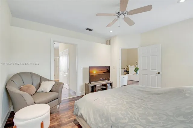 a view of a livingroom with a ceiling fan and wooden floor