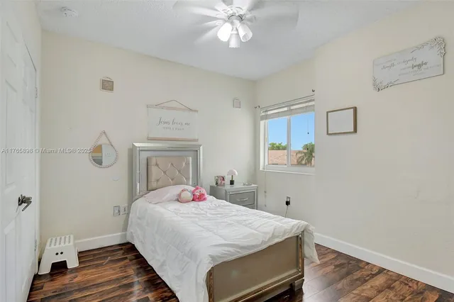 a living room with hardwood floor and a flat screen tv