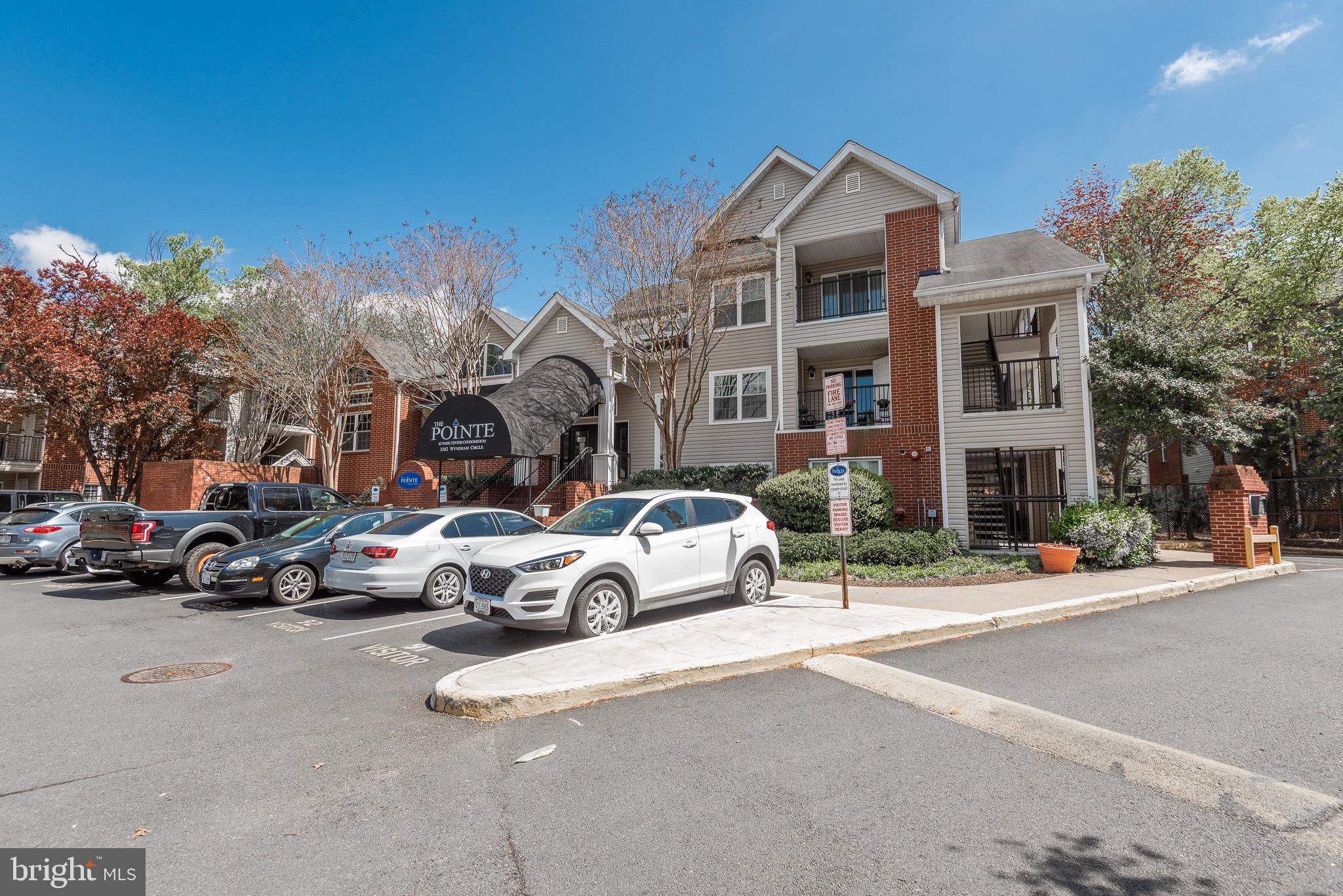 3310 Wyndham Circle, Unit 314 Alexandria, VA 22302 - Photo 15 of 31 a view of a cars parked in front of a building