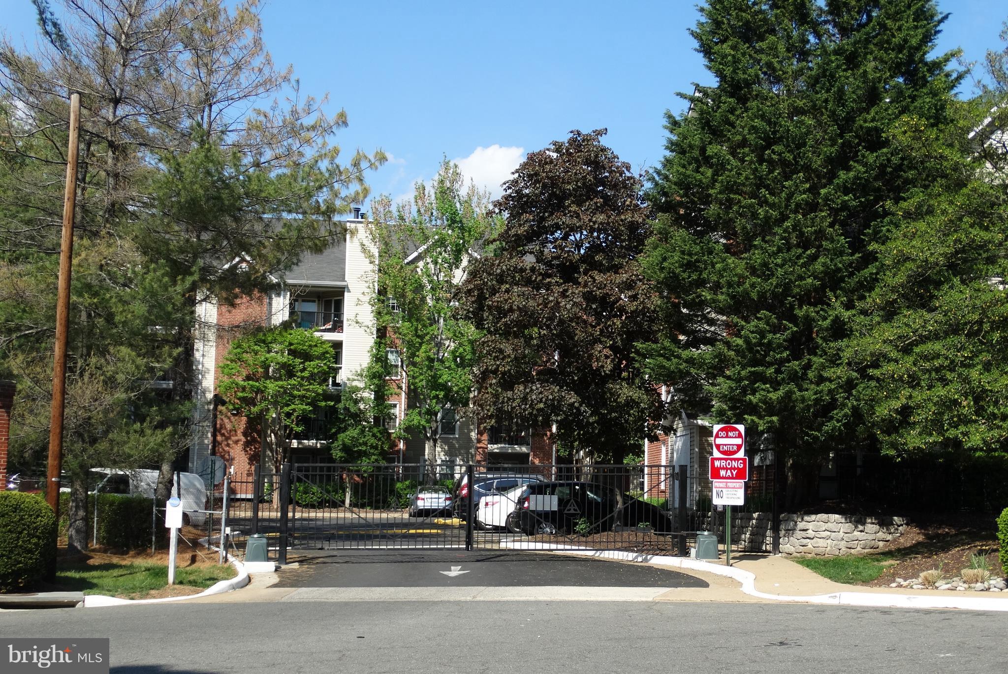 3310 Wyndham Circle, Unit 314 Alexandria, VA 22302 - Photo 17 of 31 a building with trees in front of it
