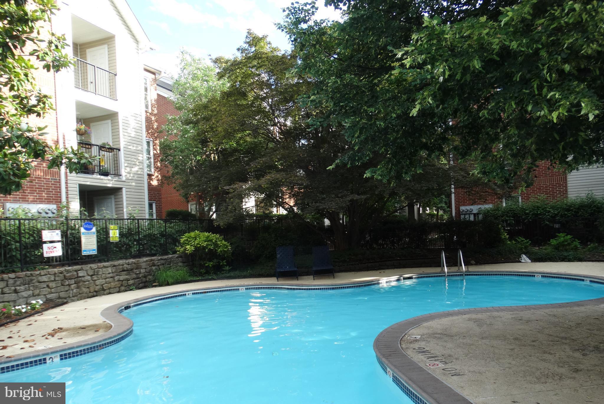 3310 Wyndham Circle, Unit 314 Alexandria, VA 22302 - Photo 25 of 31 a view of a swimming pool with a yard