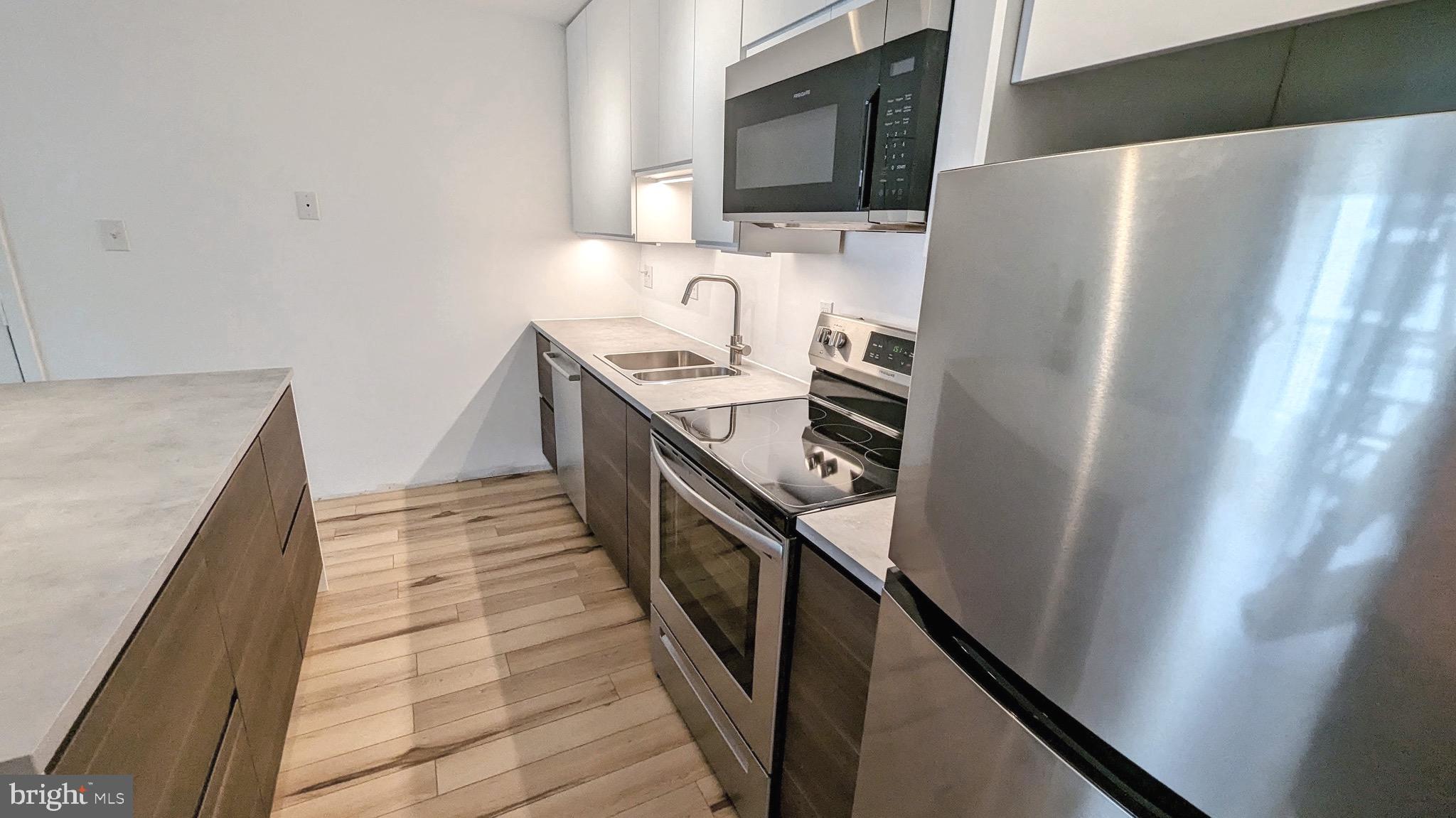 3310 Wyndham Circle, Unit 314 Alexandria, VA 22302 - Photo 3 of 31 a kitchen with stainless steel appliances a refrigerator and a stove