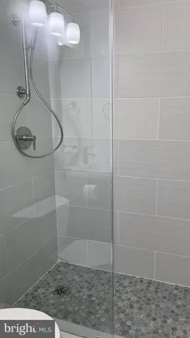 a white toilet sitting next to a shower