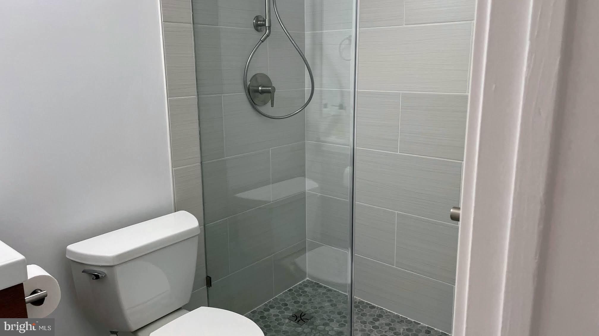 3310 Wyndham Circle, Unit 314 Alexandria, VA 22302 - Photo 9 of 31 a white toilet sitting next to a shower