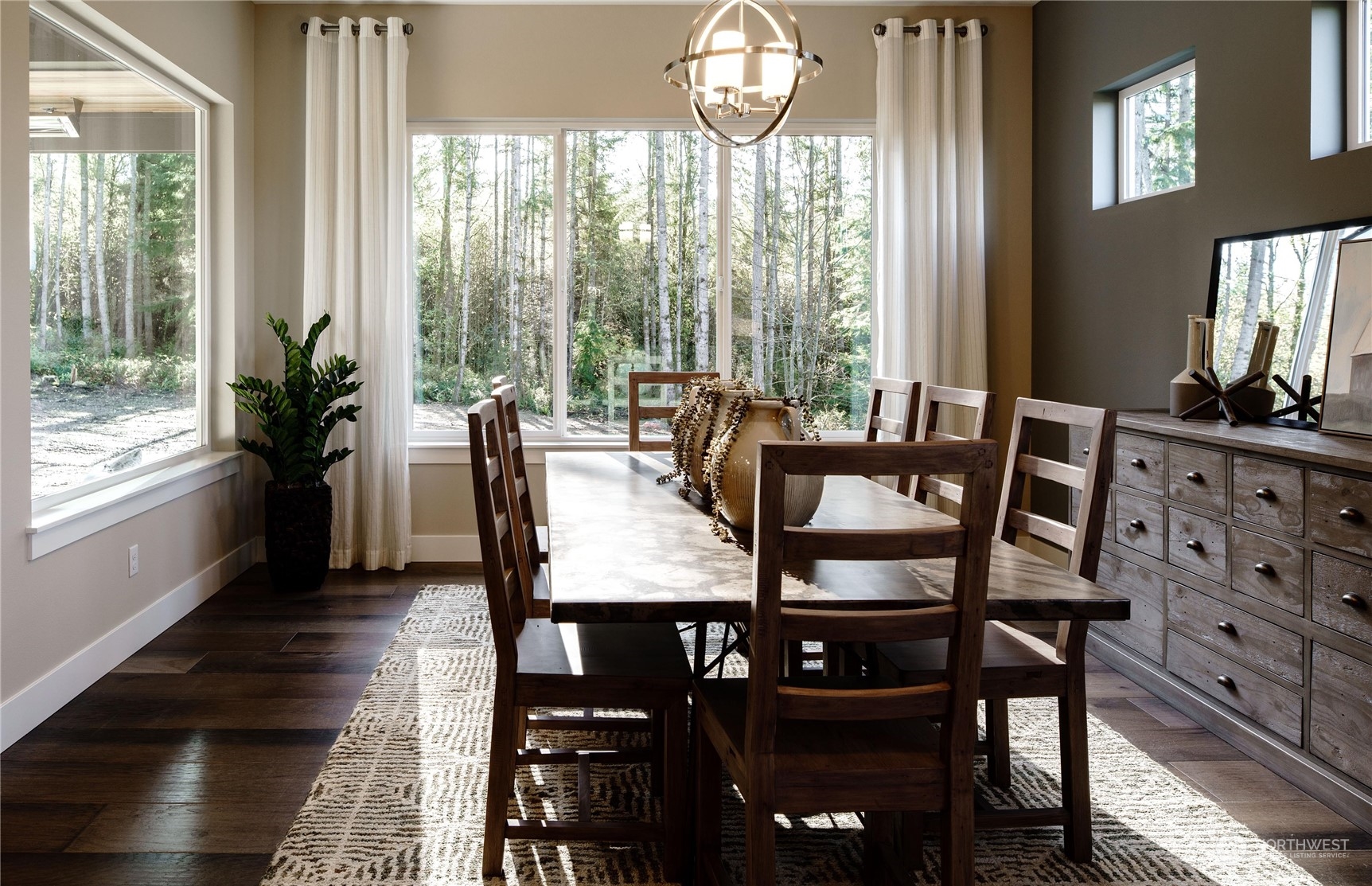 3906 Northeast 27th Place, Unit 2 Renton, WA 98056 - Photo 8 of 18 a view of a dining room with furniture a chandelier and wooden floor