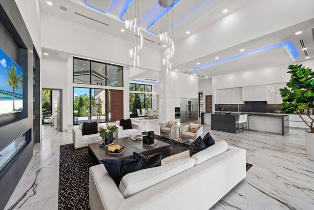 a living room with patio furniture and a flat screen tv