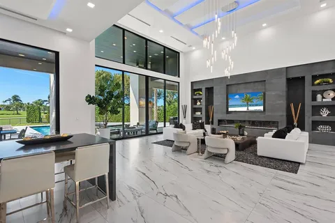a living room with furniture large window and a flat screen tv