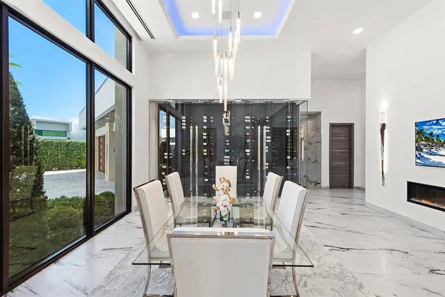 a living room with furniture a dining table and a painting on the wall
