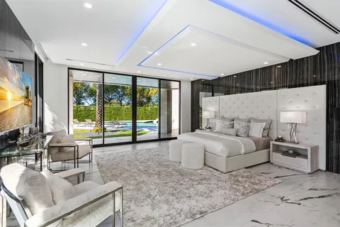 a living room with furniture a large window and a flat screen tv