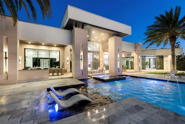 a living room with furniture and large windows