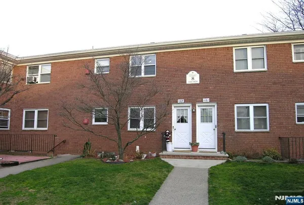 a front view of a house with a yard and glass windows