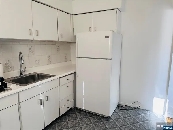 a white refrigerator freezer sitting inside of a kitchen