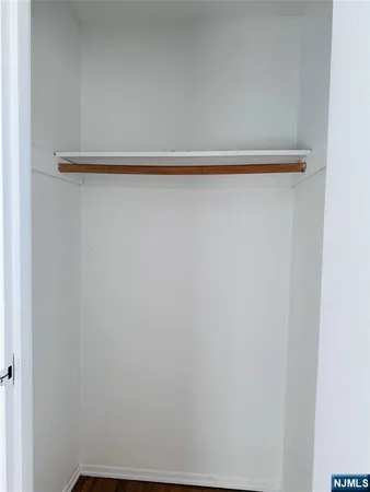 a view of a closet with wooden floor