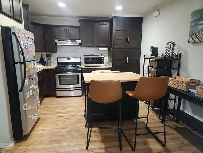 1304 Summit Street, Unit 208 Austin, TX 78741 - Photo 5 of 18 Kitchen with stainless steel appliances, ample storage, and a kitchen island for extra prep space!