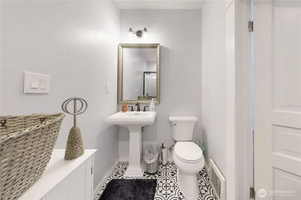 a bathroom with a toilet sink and mirror