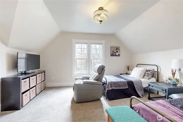 a bedroom with bed and flat screen tv