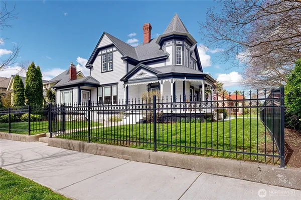 a front view of a house with a garden and plants