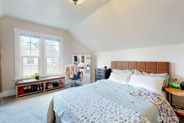 a bedroom with a bed and a couch