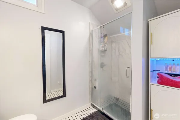 a bathroom with a shower and a sink