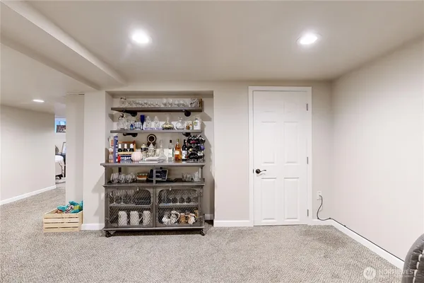 a view of a house with a small yard plants and large trees