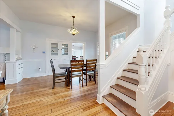 a view of a dining room with furniture and wooden floor