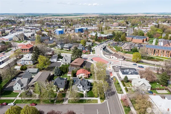 an aerial view of a house with a yard basket ball court and outdoor seating