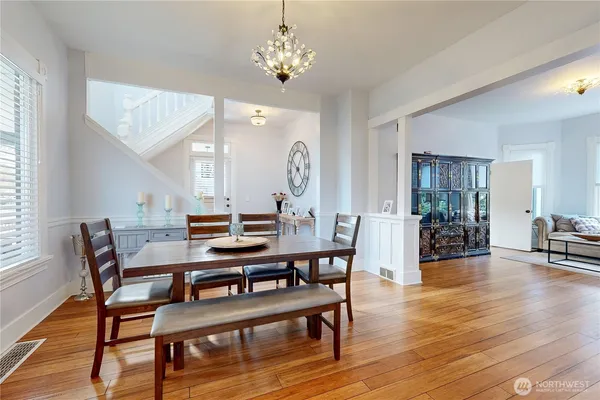 a view of a dining room with furniture and wooden floor