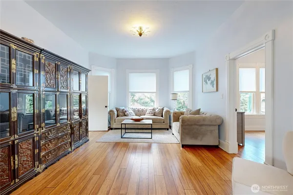 a living room with furniture and a wooden floor