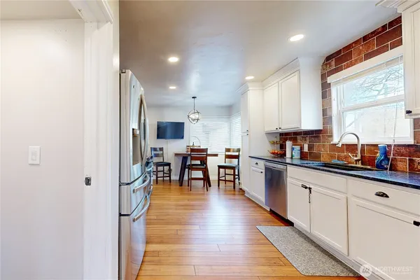 a kitchen with stainless steel appliances a refrigerator and a sink