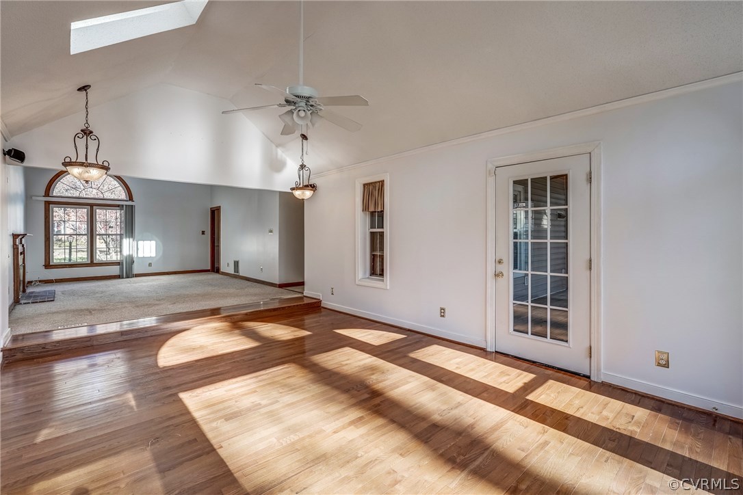 6205 Lansgate Road Midlothian, VA 23112 - Photo 22 of 50 a view of a livingroom with wooden floor and a ceiling fan