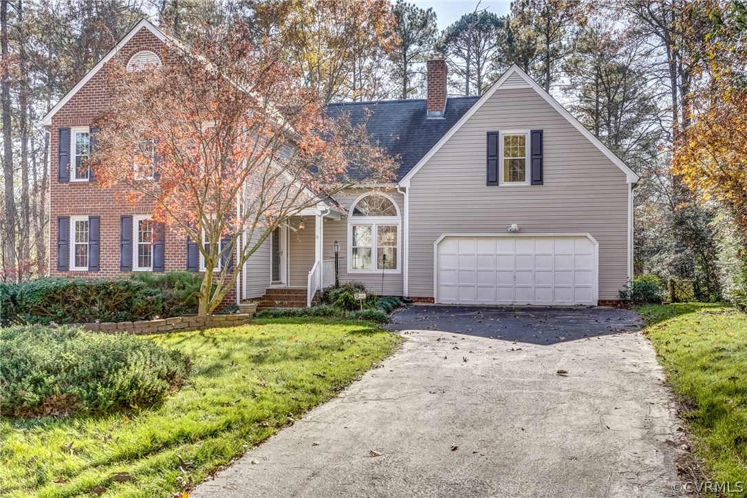 6205 Lansgate Road Midlothian, VA 23112 - Photo 3 of 50 a front view of a house with a yard and garage