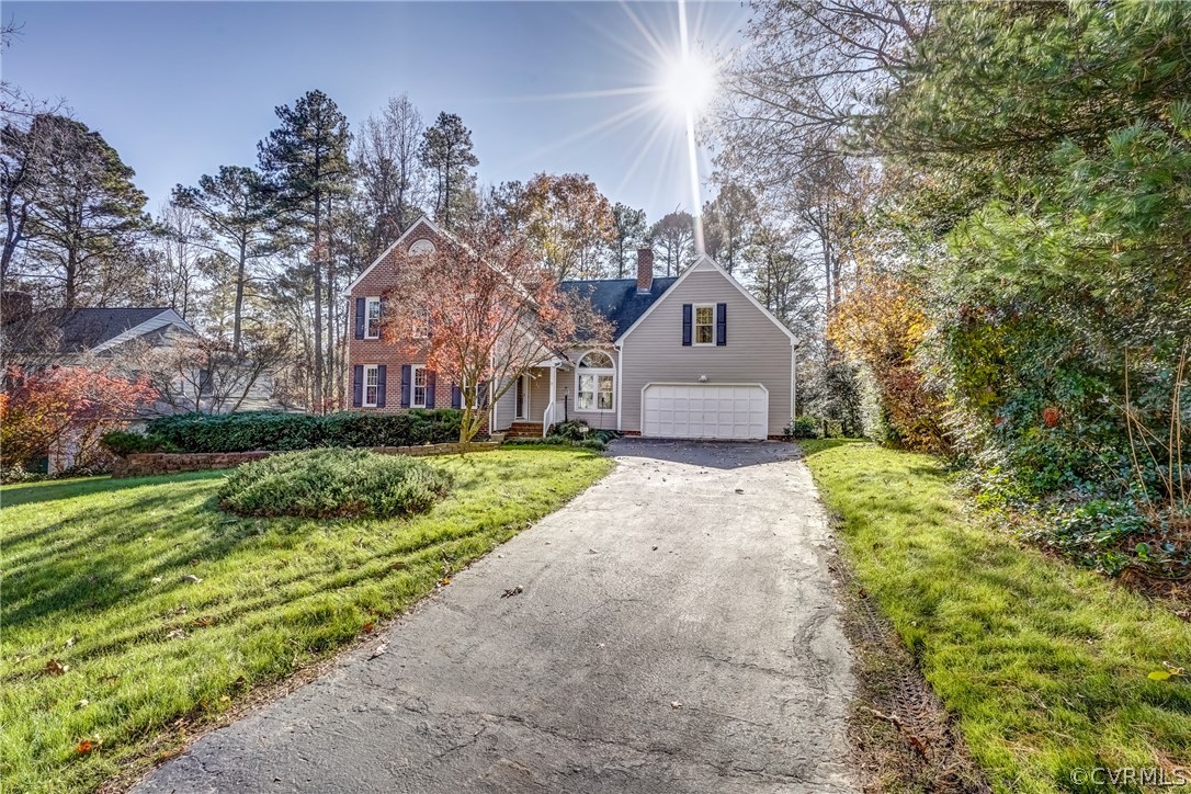 6205 Lansgate Road Midlothian, VA 23112 - Photo 4 of 50 a front view of a house with a yard and large trees